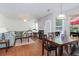 Open living and dining area with hardwood floors and natural light, centered on a fireplace at 5857 Cobalt Dr, Powder Springs, GA 30127