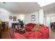 Inviting living room with red sofa, area rug, wall decor, and a view of an adjacent dining area at 5857 Cobalt Dr, Powder Springs, GA 30127