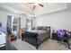 Spacious main bedroom featuring a tray ceiling, neutral décor, and large windows with curtains at 5857 Cobalt Dr, Powder Springs, GA 30127