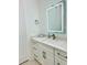 Bathroom with modern illuminated mirror, white countertops, and stylish fixtures at 2964 Old Peachtree Rd, Dacula, GA 30019