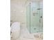 This gorgeous bathroom is styled with a glass shower and soaking tub surrounded by marble tile at 2964 Old Peachtree Rd, Dacula, GA 30019