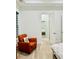 Cozy bedroom with an orange reading chair, with light wooden floors and minimal decorations at 2964 Old Peachtree Rd, Dacula, GA 30019
