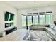 Bright living room featuring a fireplace, modern entertainment center, and large windows at 2964 Old Peachtree Rd, Dacula, GA 30019