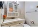 Bright bathroom featuring a white vanity with storage, toilet, and neutral walls at 263 Lynn Dr, Fayetteville, GA 30215