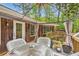 Elevated deck with a view showcases wicker furniture, a table, and serene outdoor living at 263 Lynn Dr, Fayetteville, GA 30215