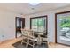 Cozy dining area with table setting, hardwood floors, natural lighting, and access to the outdoor deck at 263 Lynn Dr, Fayetteville, GA 30215