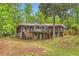 Back exterior view of a multi-story home with a large deck overlooking the lush backyard at 263 Lynn Dr, Fayetteville, GA 30215