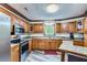 Well-equipped kitchen featuring wood cabinetry, stainless steel appliances, and ample counter space for cooking at 263 Lynn Dr, Fayetteville, GA 30215