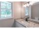 Bathroom with granite countertops, sink and a view of a wooded backyard at 5139 Coolamber Dr, Powder Springs, GA 30127