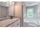 This luxurious bathroom features a double vanity, granite countertops and a stand alone tub at 5139 Coolamber Dr, Powder Springs, GA 30127
