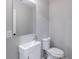 Modern powder room featuring a stylish vanity sink, mirror, and toilet, designed for contemporary living at 5139 Coolamber Dr, Powder Springs, GA 30127