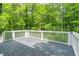 Exterior deck with a wood finish and white rails is the perfect place to enjoy the treed backyard view at 5139 Coolamber Dr, Powder Springs, GA 30127