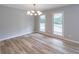 This bright dining room is illuminated by a modern chandelier and features wood floors and natural lighting at 5139 Coolamber Dr, Powder Springs, GA 30127