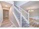 Inviting entryway featuring hardwood floors, a staircase with white railings, and views into adjoining rooms at 5139 Coolamber Dr, Powder Springs, GA 30127