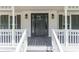 Home's covered front porch and main entrance at 5139 Coolamber Dr, Powder Springs, GA 30127