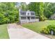 Inviting home featuring a spacious front yard, driveway, and a covered front porch at 5139 Coolamber Dr, Powder Springs, GA 30127