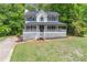 Attractive home with a large front yard and a welcoming, covered porch at 5139 Coolamber Dr, Powder Springs, GA 30127