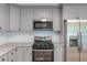 This updated kitchen features stainless steel appliances, granite countertops and modern cabinets at 5139 Coolamber Dr, Powder Springs, GA 30127