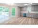 Modern kitchen with stainless steel appliances and blue dishwasher that is set against a backdrop of grey cabinets and hardwood floors at 5139 Coolamber Dr, Powder Springs, GA 30127
