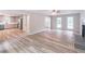Expansive living room with hardwood floors, a fireplace, and an open view into the kitchen at 5139 Coolamber Dr, Powder Springs, GA 30127