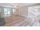 Open-concept living room with fireplace, hardwood floors, and a staircase leading upstairs at 5139 Coolamber Dr, Powder Springs, GA 30127