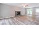 Spacious living room with hardwood floors, a brick fireplace, and large windows at 5139 Coolamber Dr, Powder Springs, GA 30127