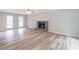 Spacious living room with hardwood floors, a fireplace, and multiple windows at 5139 Coolamber Dr, Powder Springs, GA 30127