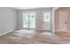 Bright living room with hardwood floors, a back door, and windows showcasing the view outside at 5139 Coolamber Dr, Powder Springs, GA 30127