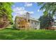 Backyard featuring a two-level deck, lush green lawn and mature trees at 6990 N Glen Dr, Cumming, GA 30028