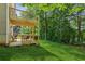 Multi-level deck and green backyard surrounded by trees and green foliage at 6990 N Glen Dr, Cumming, GA 30028
