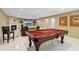 Open basement layout with a cozy fireplace, a pool table, and recessed lighting at 6990 N Glen Dr, Cumming, GA 30028
