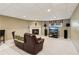 Finished basement with a fireplace, TV, and a comfy leather recliner at 6990 N Glen Dr, Cumming, GA 30028
