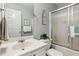 Well-lit bathroom featuring a vanity sink, toilet, and shower over tub combo at 6990 N Glen Dr, Cumming, GA 30028