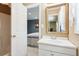 Bathroom featuring a white vanity, decorative mirror and adjacent bedroom at 6990 N Glen Dr, Cumming, GA 30028