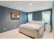 Blue bedroom with matching curtains, bedding, and a decorative wood mirror at 6990 N Glen Dr, Cumming, GA 30028
