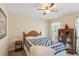 Cozy bedroom with a wooden bed frame, blue and white quilt, and vintage cabinet at 6990 N Glen Dr, Cumming, GA 30028