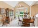 Bright dining room with a bay window, elegant chandelier, and classic furniture at 6990 N Glen Dr, Cumming, GA 30028