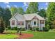 Charming two-story home featuring red shutters, gray siding and a well-manicured lawn at 6990 N Glen Dr, Cumming, GA 30028