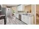 Spacious kitchen with stainless steel appliances, granite countertops, and gray wood-look floors at 6990 N Glen Dr, Cumming, GA 30028