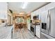 Cozy kitchen featuring stainless steel appliances, granite counters, and an adjacent breakfast nook at 6990 N Glen Dr, Cumming, GA 30028