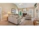 Inviting living room featuring a stone fireplace, soft lighting, and plush seating at 6990 N Glen Dr, Cumming, GA 30028