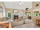 Comfortable living room with fireplace, neutral furniture, and bright natural light at 6990 N Glen Dr, Cumming, GA 30028
