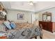 Inviting main bedroom with a tray ceiling, and wooden dresser at 6990 N Glen Dr, Cumming, GA 30028