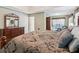 Comfortable main bedroom featuring a patterned bedspread and wooden furniture at 6990 N Glen Dr, Cumming, GA 30028