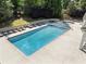Large rectangle outdoor pool and spa surrounded by lounge chairs at 6990 N Glen Dr, Cumming, GA 30028