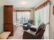 Cozy sitting room with two leather chairs and a built-in cabinet at 6990 N Glen Dr, Cumming, GA 30028
