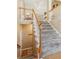Carpeted staircase with white railings, leading to a cozy upper level at 6990 N Glen Dr, Cumming, GA 30028