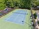 Overhead view of tennis court with adjacent playground and surrounding trees at 6990 N Glen Dr, Cumming, GA 30028
