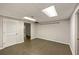 The finished basement has tiled floors, a drop ceiling, and a white louvered door at 2912 Dunhill Trl, Woodstock, GA 30189