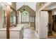 Bright bathroom featuring double vanity, soaking tub, walk-in shower, and vaulted ceilings at 2912 Dunhill Trl, Woodstock, GA 30189